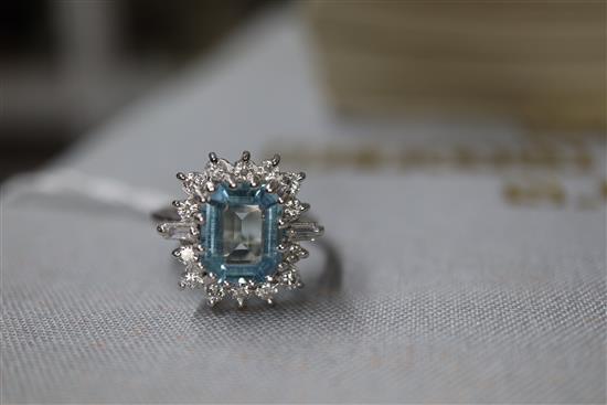 A modern 18ct white metal, aquamarine, baguette and round cut diamond set cluster ring, size K/L.